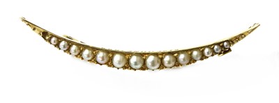 Lot 39 - A gold split pearl open crescent brooch