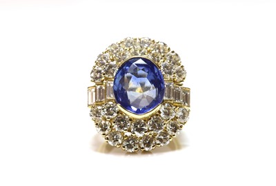 Lot 413 - A two row sapphire and diamond oval cluster ring