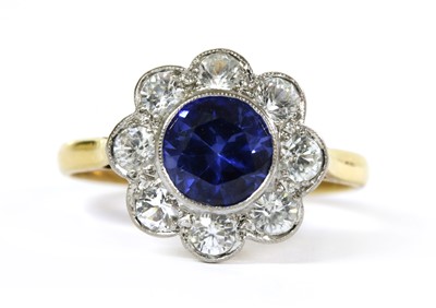 Lot 259 - An 18ct gold synthetic blue and white sapphire daisy cluster ring