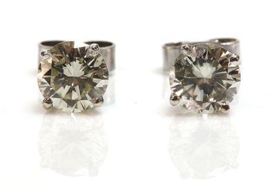 Lot 453 - A pair of single stone diamond earrings
