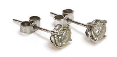 Lot 453 - A pair of single stone diamond earrings