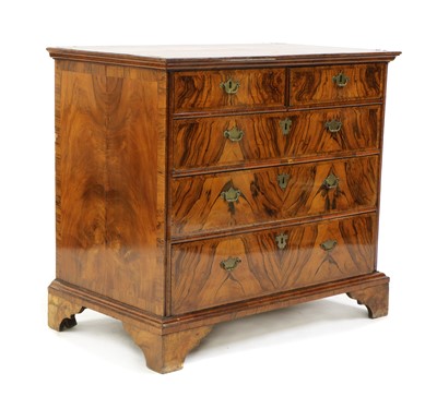 Lot 494 - A walnut chest of two short over three long drawers