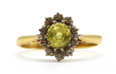 Lot 144 - A gold yellow sapphire and diamond cluster ring
