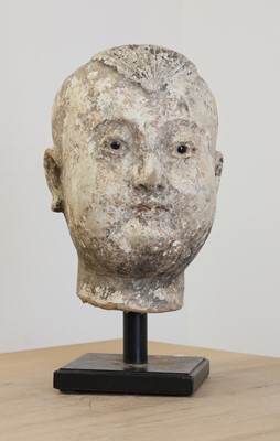 Lot 803 - A Ming-style stucco and polychrome painted head of a child