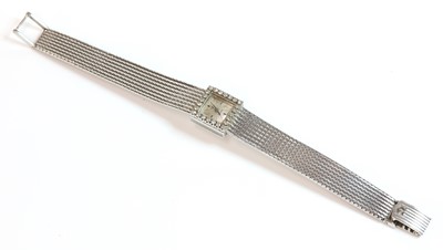 Lot 224 - A ladies' 18ct white gold Omega diamond set mechanical bracelet watch, c.1960
