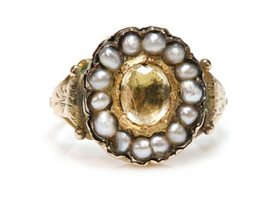 Lot 24 - A Georgian foiled topaz and split pearl ring