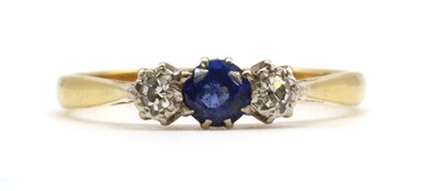 Lot 180 - A gold three stone sapphire and diamond ring