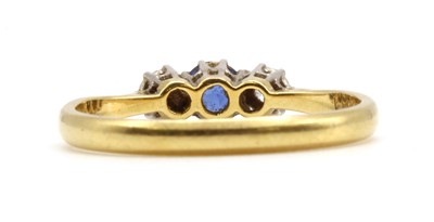Lot 180 - A gold three stone sapphire and diamond ring