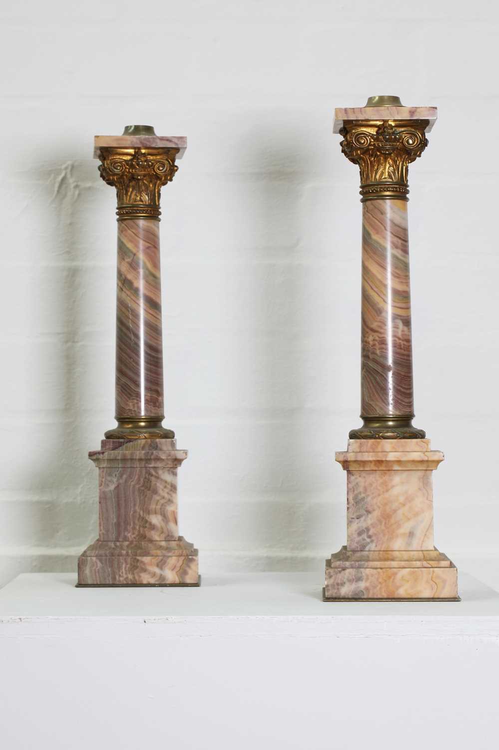 Lot 225 - A pair of veined pink marble lamp bases