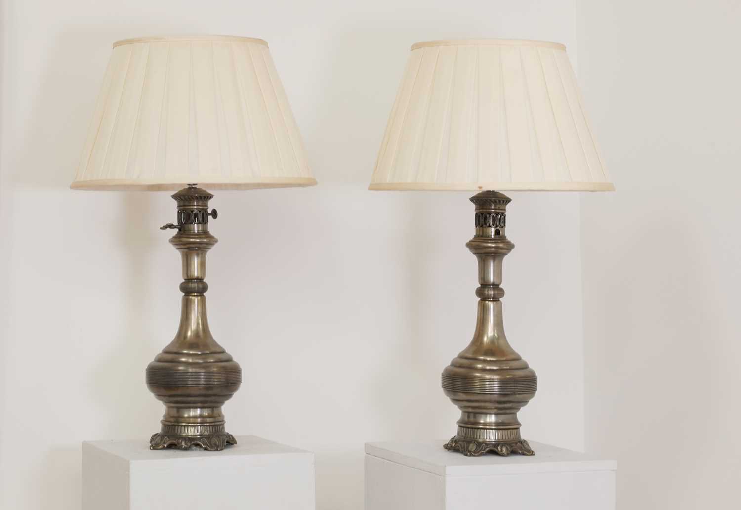Lot 101 - A pair of Napoleon III silver-plated moderator oil lamps