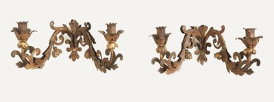 Lot 62 - A set of four pressed and gilt-metal twin-branch wall sconces