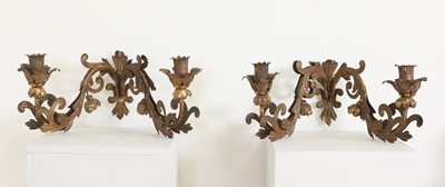 Lot 62 - A set of four pressed and gilt-metal twin-branch wall sconces
