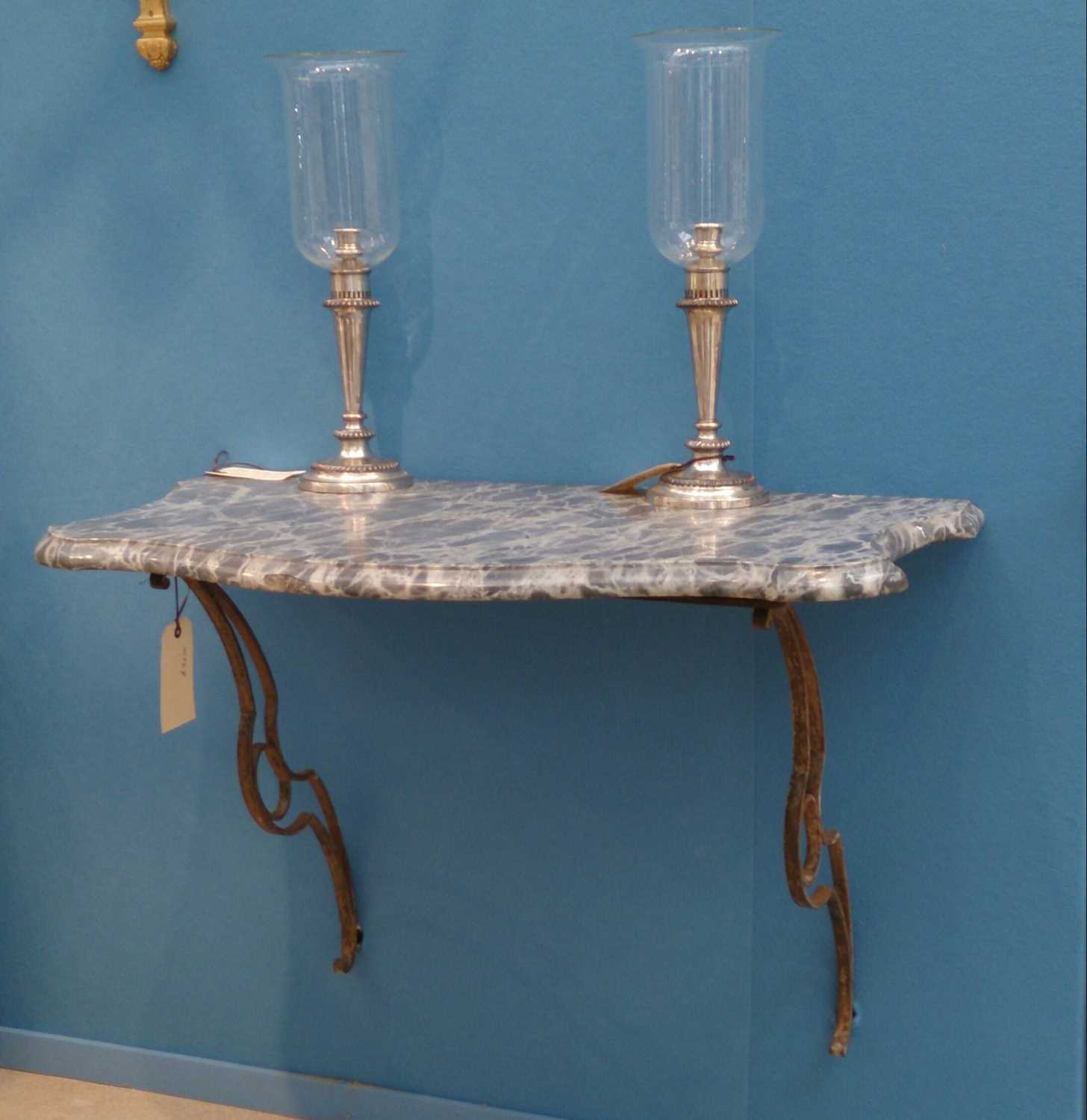 Lot 108 - A pair of marble-topped wall-mounted wrought iron pier tables