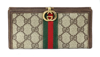 Lot 390 - A Gucci coated canvas monogrammed purse