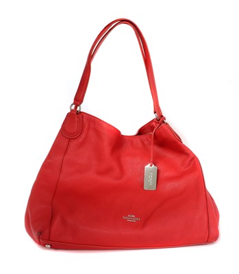 Lot 384 - A Coach red leather Edie bag