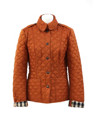 Lot 325 - A Burberry burnt orange Brit padded jacket