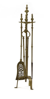 Lot 505 - A set of three brass fireside implements