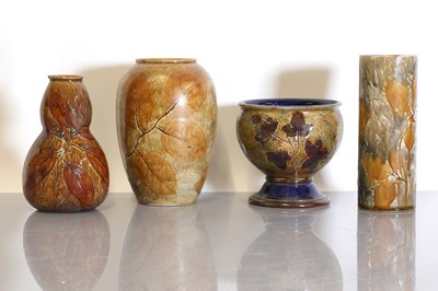 Lot 34 - Four Royal Doulton 'Foliage ware' stoneware vases and a jardinière
