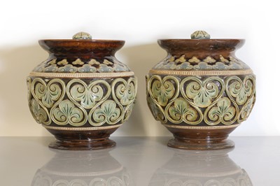 Lot 15 - A pair of Doulton Lambeth stoneware vases and covers