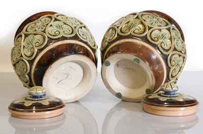 Lot 15 - A pair of Doulton Lambeth stoneware vases and covers