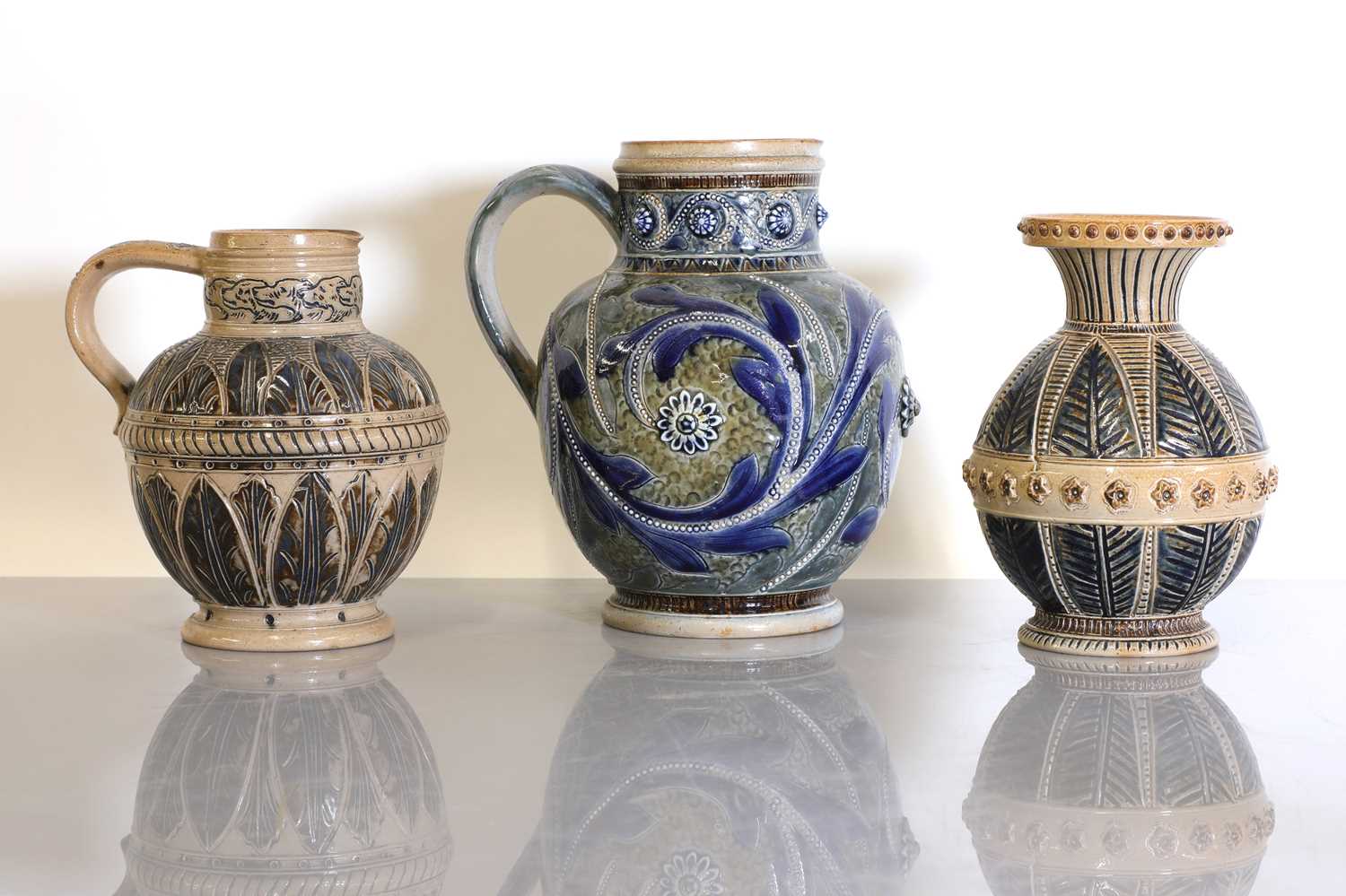 Lot 40 - Two Doulton Lambeth stoneware jugs and a vase