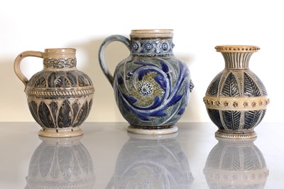 Lot 40 - Two Doulton Lambeth stoneware jugs and a vase