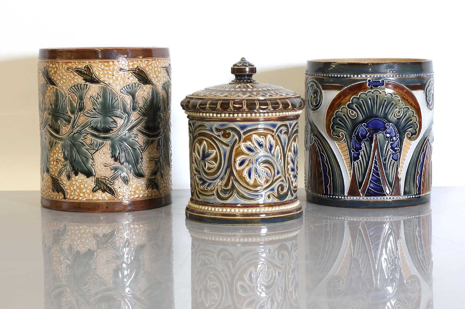 Lot 41 - A Doulton Lambeth stoneware tobacco jar and two pots