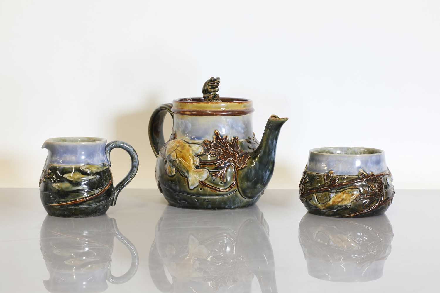 Lot 1 - A Royal Doulton stoneware three-piece tea set