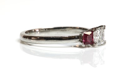 Lot 100 - A platinum three stone diamond and ruby ring