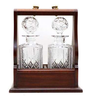 Lot 108 - A tantalus with a pair of cut glass decanters