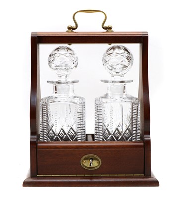 Lot 108 - A tantalus with a pair of cut glass decanters