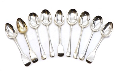 Lot 3 - A group of four George III Fiddle pattern silver dessert spoons