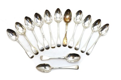 Lot 1 - A collection of seven George III and IV Fiddle pattern silver serving spoons