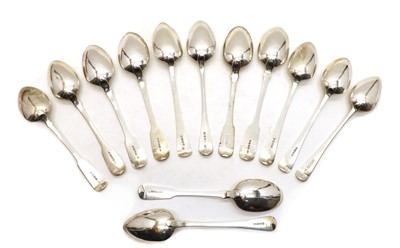 Lot 1 - A collection of seven George III and IV Fiddle pattern silver serving spoons
