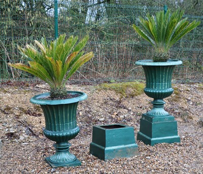 Lot 412 - A pair of large cast iron urns on stands