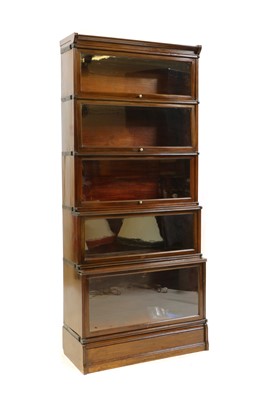 Lot 490 - A five section walnut modular bookcase