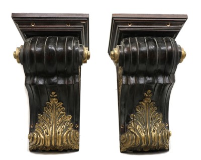 Lot 401 - A pair of ebonised and parcel gilt corbels