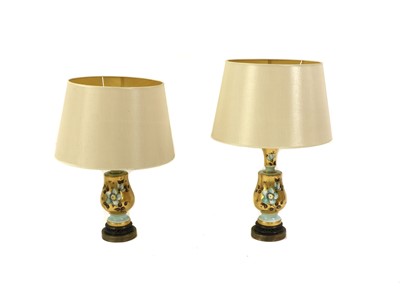Lot 201 - A pair of gilt porcelain table lamps