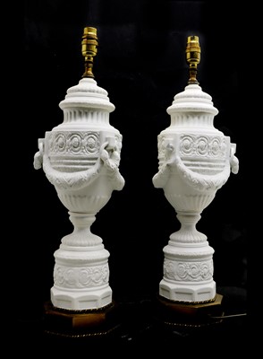 Lot 203 - A pair of white bisque porcelain table lamps