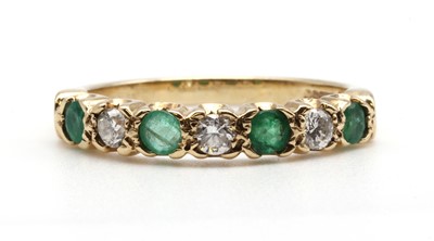 Lot 172 - A 9ct gold emerald and diamond half eternity ring