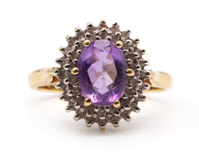Lot 219 - A gold amethyst and diamond cluster ring