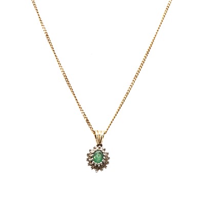 Lot 160 - A gold emerald and diamond cluster pendant