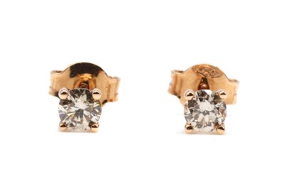 Lot 62 - A pair of rose gold single stone diamond stud earrings