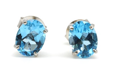 Lot 183 - A pair of silver single stone blue topaz stud earrings