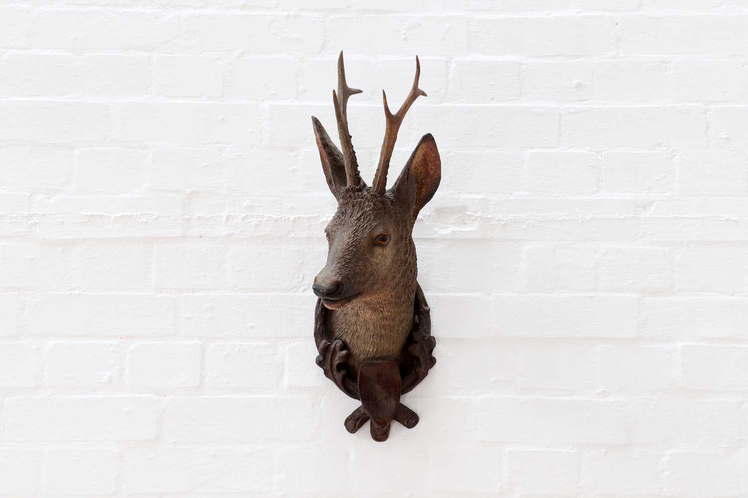 Lot 505 - A Black Forest terracotta roebuck trophy head