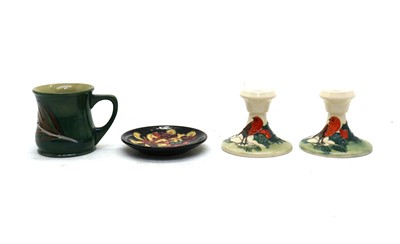 Lot 190A - A pair of Moorcroft pottery ‘Christmas Robin’ dwarf candlesticks