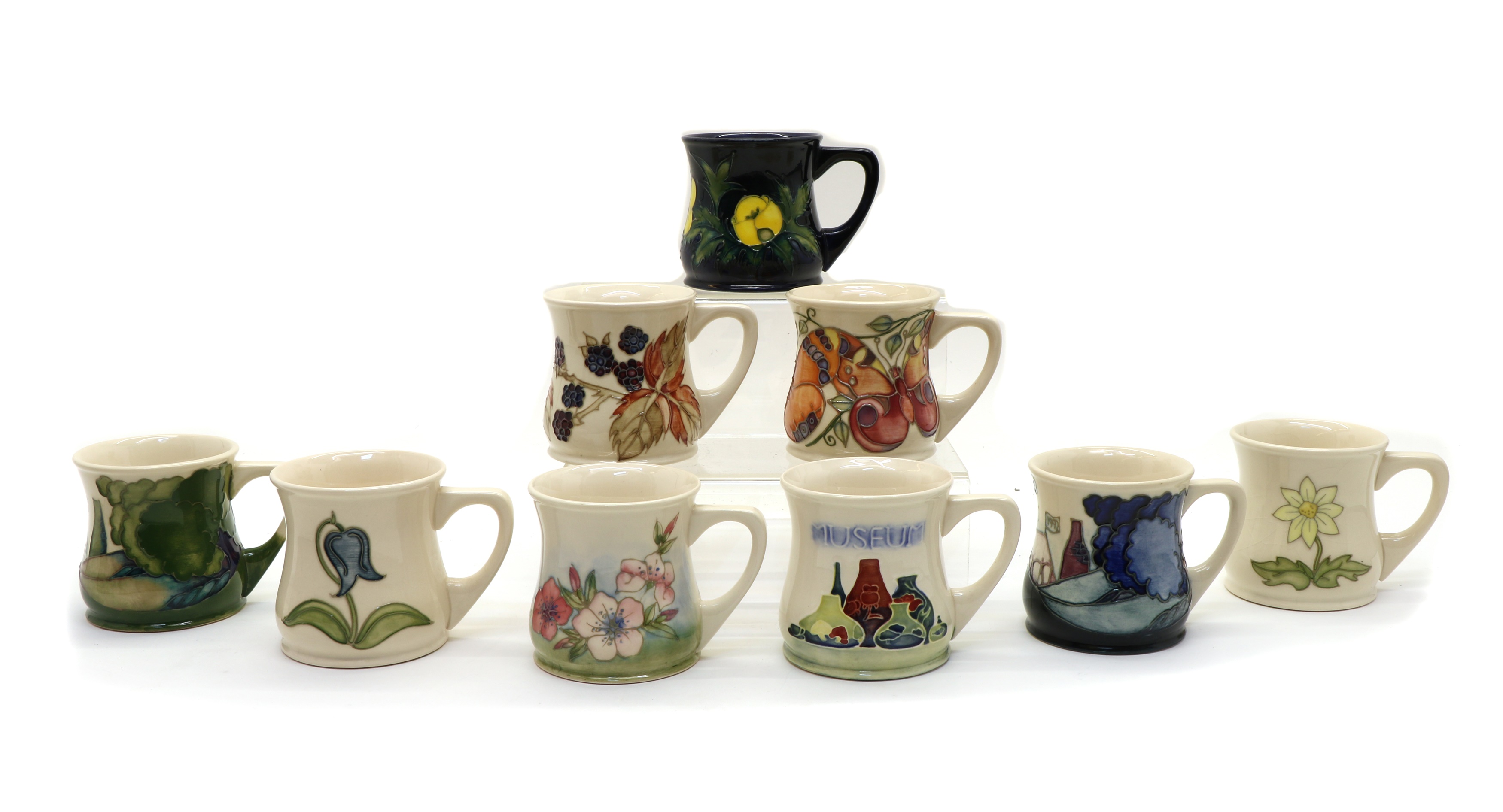 Lot 92 A collection of Moorcroft pottery mugs,