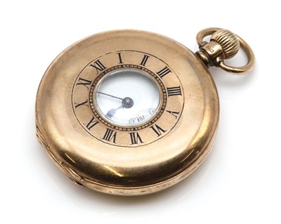 Lot 557 - A 9ct gold half hunter top wind pocket watch