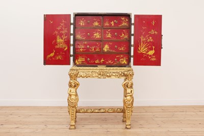 Lot 7 - A lacquered, inlaid and gilt-heightened cabinet on stand