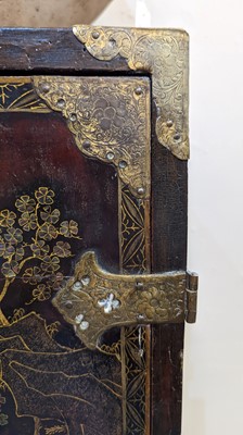 Lot 7 - A lacquered, inlaid and gilt-heightened cabinet on stand